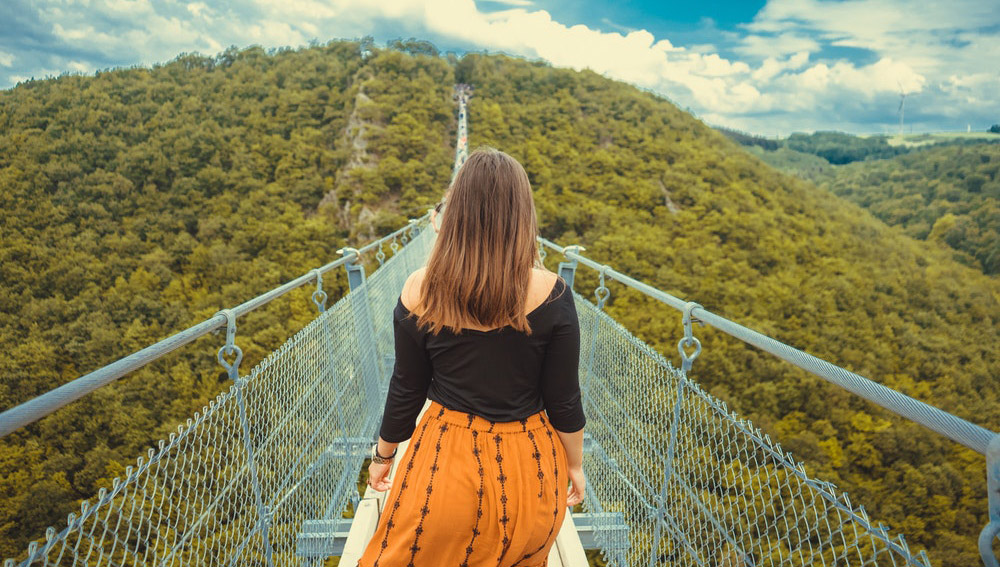 Woman walking on bridge
